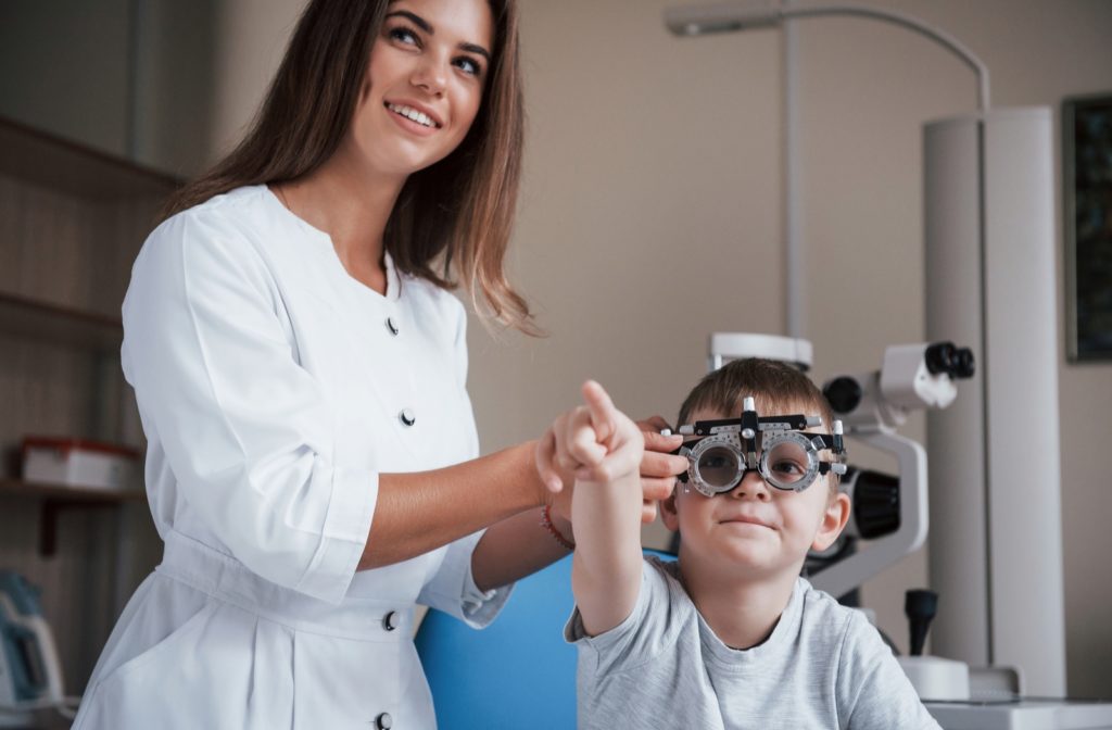 A young boy at the optometrist getting his visual acuity tested